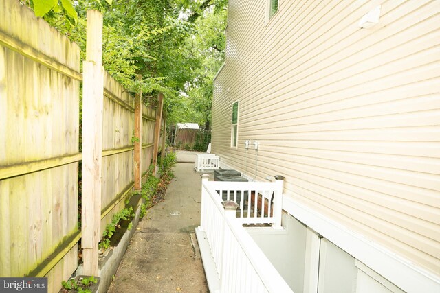 view of side of home featuring fence
