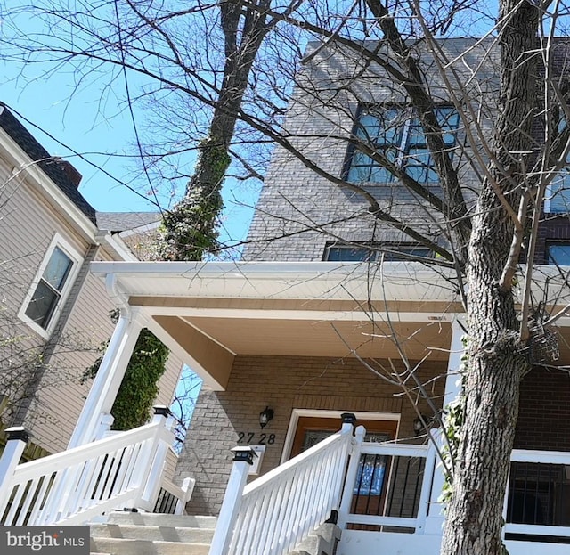 exterior space featuring brick siding