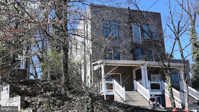 view of front of house featuring stairs and a porch