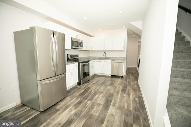 kitchen featuring white cabinetry, recessed lighting, dark wood finished floors, and stainless steel appliances