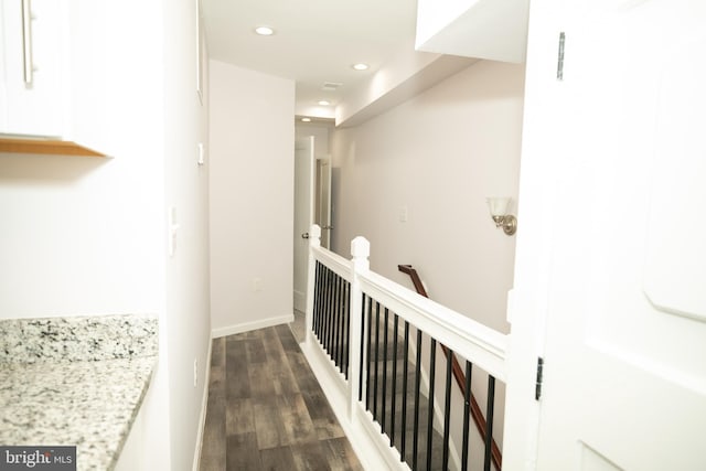 hallway featuring recessed lighting, an upstairs landing, dark wood-style floors, and baseboards
