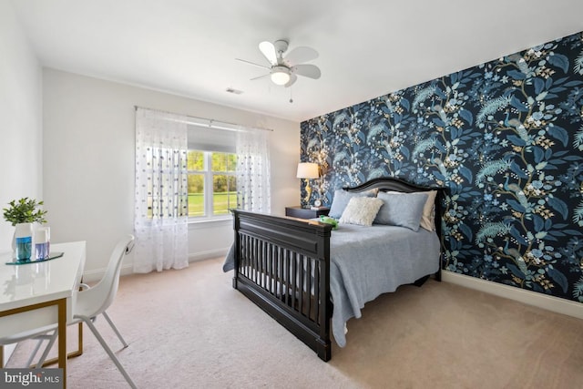 carpeted bedroom with a ceiling fan, visible vents, wallpapered walls, and baseboards