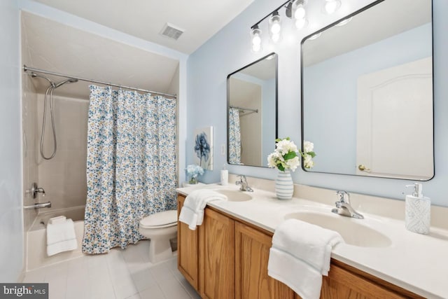 bathroom with tile patterned flooring, double vanity, visible vents, toilet, and a sink