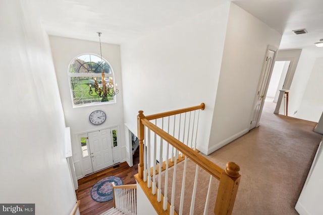 entrance foyer featuring visible vents and a notable chandelier