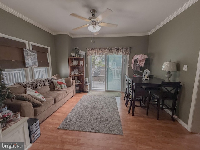 living area featuring crown molding, a ceiling fan, and wood finished floors