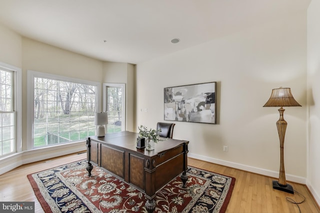 office area with light wood finished floors and baseboards