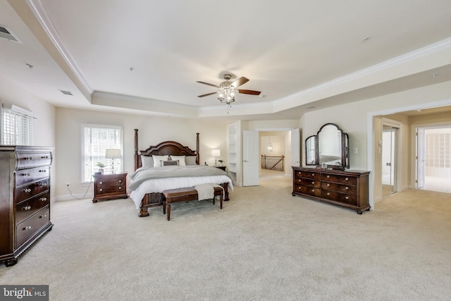 carpeted bedroom featuring a raised ceiling, visible vents, and ornamental molding