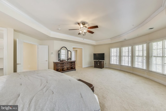 bedroom featuring a raised ceiling, visible vents, carpet floors, crown molding, and baseboards