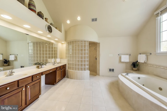 bathroom with plenty of natural light, visible vents, a sink, and a whirlpool tub