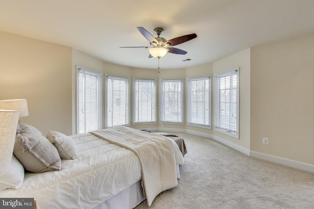bedroom with visible vents, baseboards, carpet, and ceiling fan