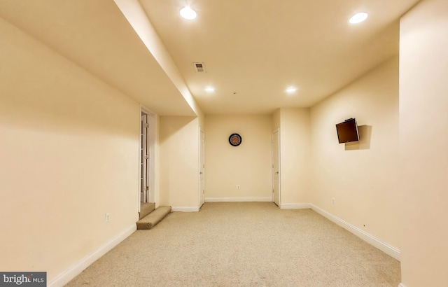 finished basement with recessed lighting, baseboards, and light carpet