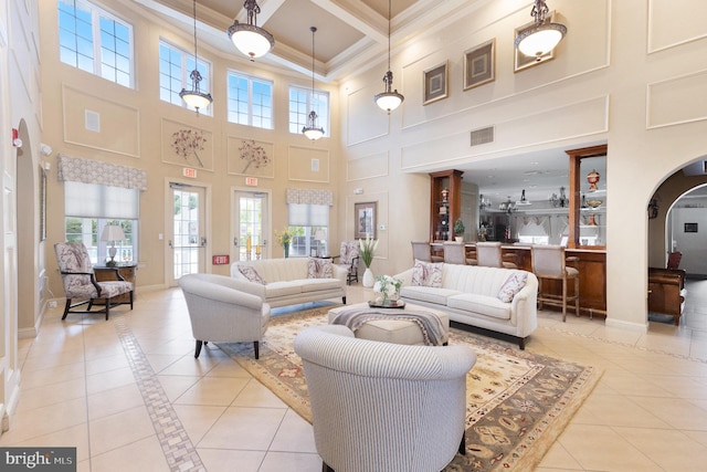32 Dresner Cir, Upper Chichester, PA 19061 - living room with crown molding, light tile patterned flooring, a high ceiling, arched walkways, and visible vents