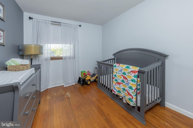 2 White Birch Ct, Turnersville, NJ 08012 - bedroom with a nursery area, baseboards, and hardwood / wood-style floors