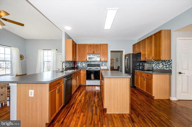 kitchen featuring tasteful backsplash, white microwave, range with electric stovetop, ceiling fan, and dishwashing machine