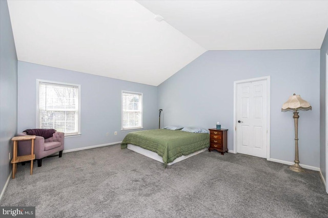 carpeted bedroom featuring baseboards and lofted ceiling