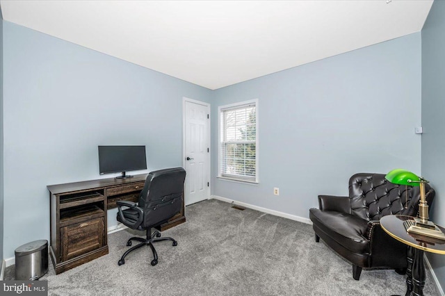 carpeted office featuring visible vents and baseboards