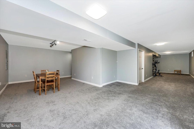 dining area with carpet flooring, visible vents, baseboards, and track lighting