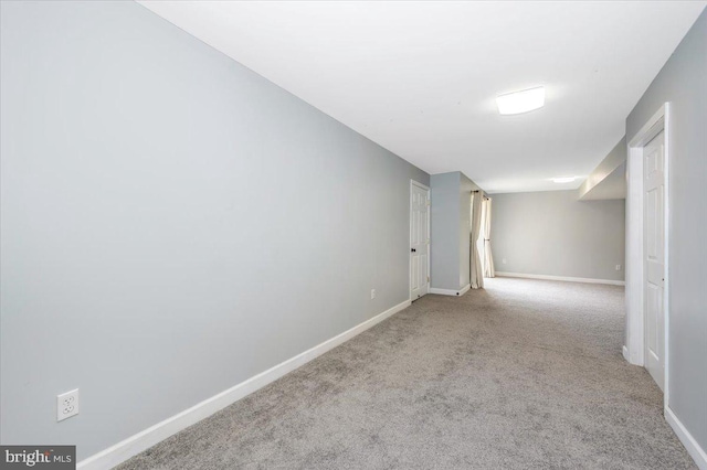 finished below grade area featuring carpet flooring and baseboards