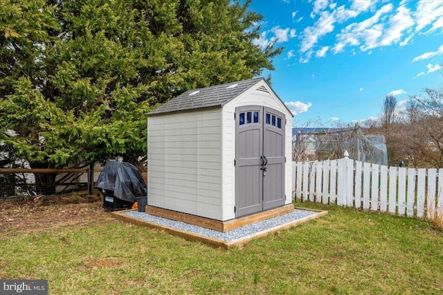 view of shed with a fenced backyard