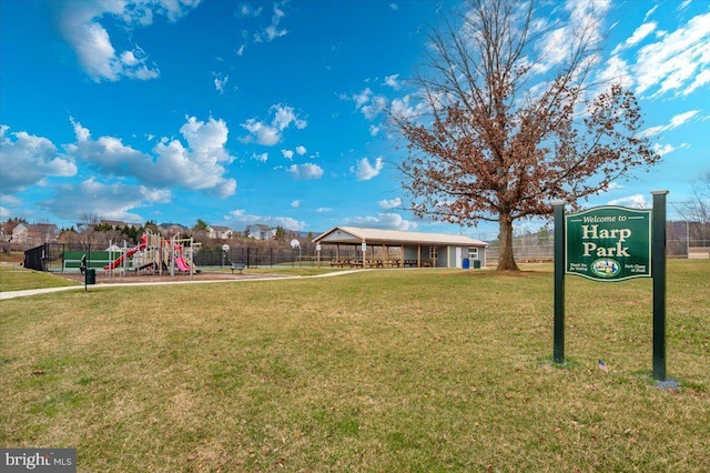 surrounding community featuring a lawn, a carport, fence, and playground community
