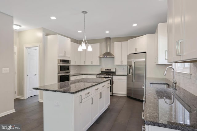 kitchen with a sink, wall chimney exhaust hood, a center island, stainless steel appliances, and white cabinetry