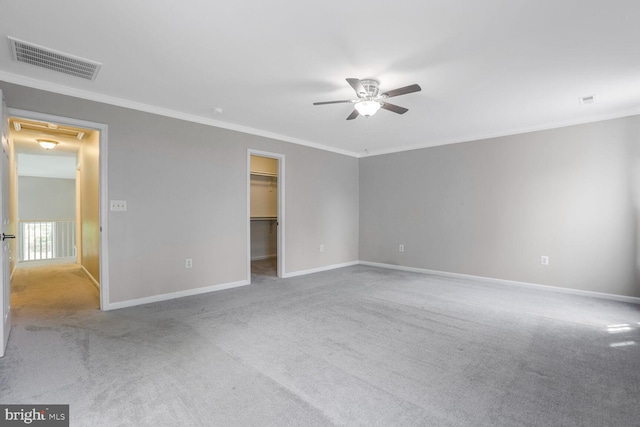 unfurnished bedroom featuring crown molding, baseboards, carpet, and visible vents