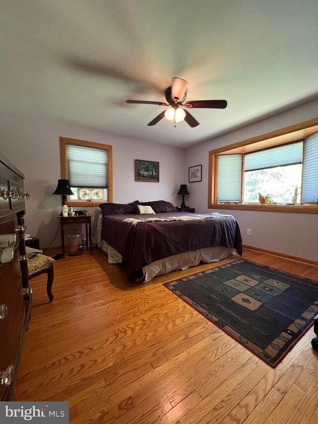 bedroom featuring ceiling fan and hardwood / wood-style flooring