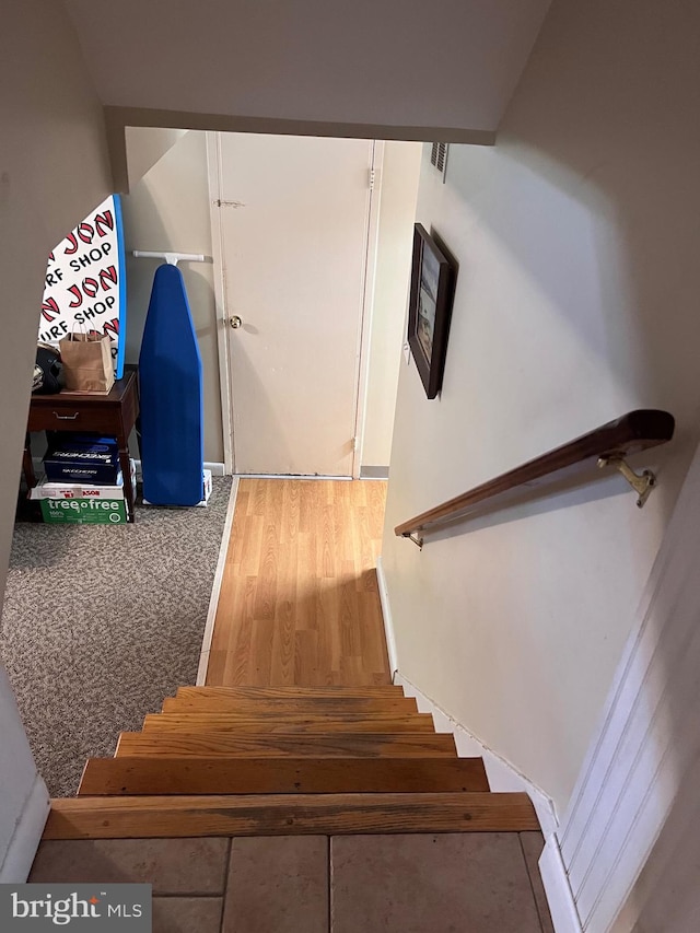 stairway with wood finished floors