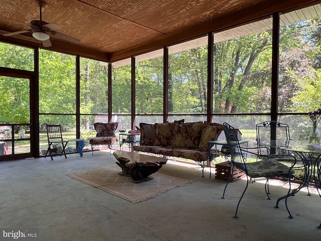 sunroom / solarium with a ceiling fan and an outdoor hangout area