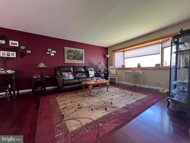 living area featuring baseboards and wood finished floors