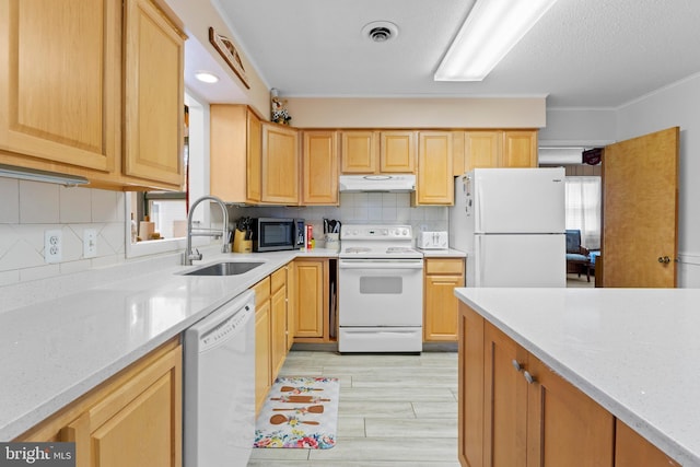 605 Old Post Ct, Bethany Beach, DE 19930 - kitchen with a sink, light brown cabinetry, white appliances, under cabinet range hood, and visible vents