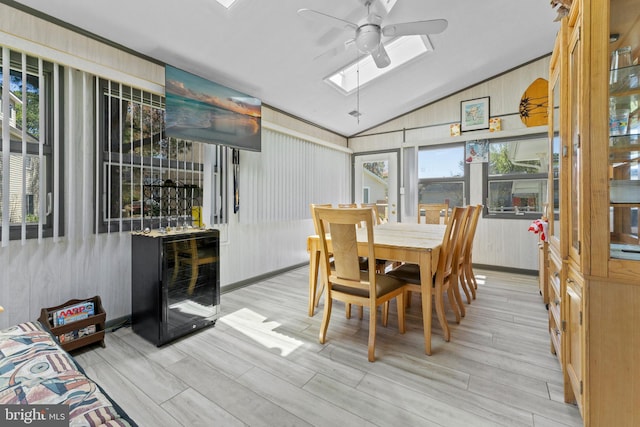 605 Old Post Ct, Bethany Beach, DE 19930 - dining room featuring wood finished floors, beverage cooler, ceiling fan, and vaulted ceiling with skylight