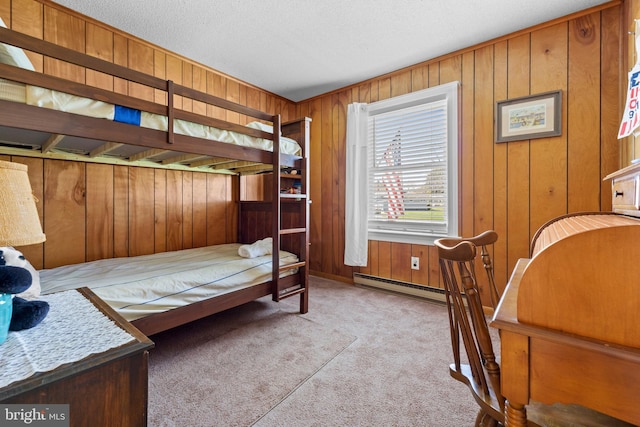 605 Old Post Ct, Bethany Beach, DE 19930 - carpeted bedroom featuring a baseboard heating unit, wood walls, and a textured ceiling
