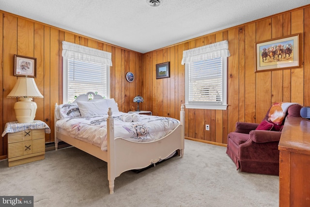 605 Old Post Ct, Bethany Beach, DE 19930 - bedroom with a textured ceiling, light carpet, wood walls, and multiple windows