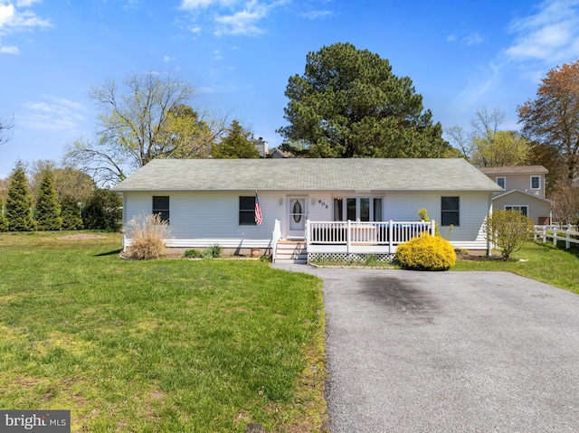 605 Old Post Ct, Bethany Beach, DE 19930 - single story home featuring a front lawn, aphalt driveway, and a chimney
