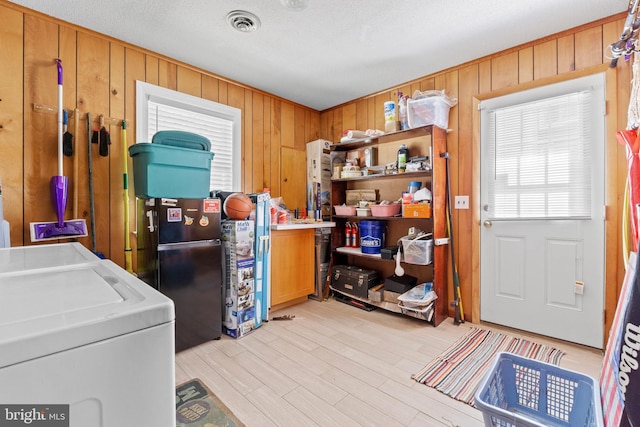 605 Old Post Ct, Bethany Beach, DE 19930 - laundry room featuring visible vents, wood walls, laundry area, and washer and clothes dryer