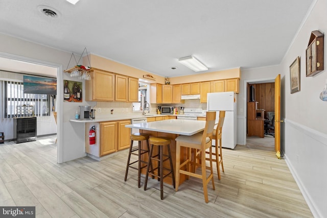605 Old Post Ct, Bethany Beach, DE 19930 - kitchen featuring visible vents, light wood finished floors, under cabinet range hood, and white appliances