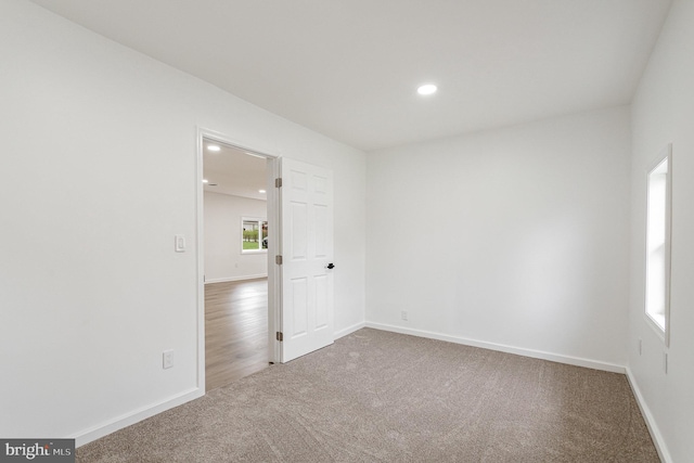 carpeted spare room with baseboards and recessed lighting