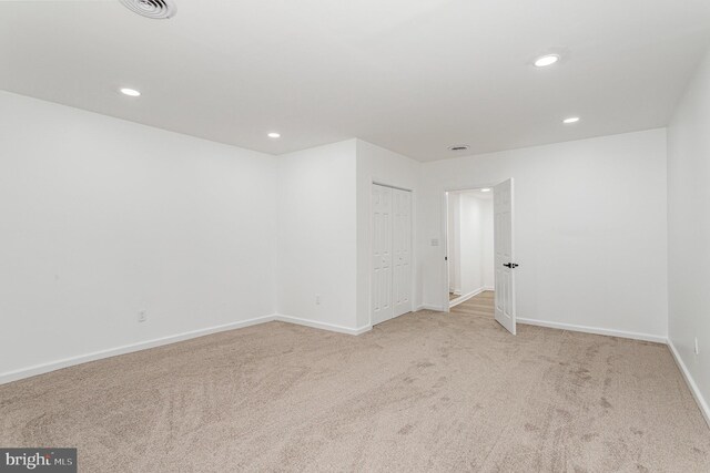 unfurnished room with carpet floors, baseboards, recessed lighting, and visible vents