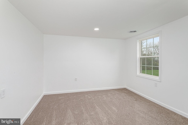 carpeted empty room featuring visible vents, baseboards, and recessed lighting