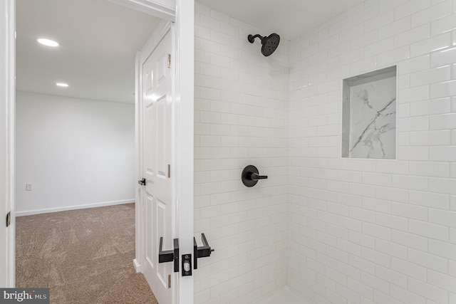 bathroom with a tile shower, recessed lighting, and baseboards