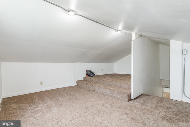 bonus room featuring baseboards, carpet, and lofted ceiling