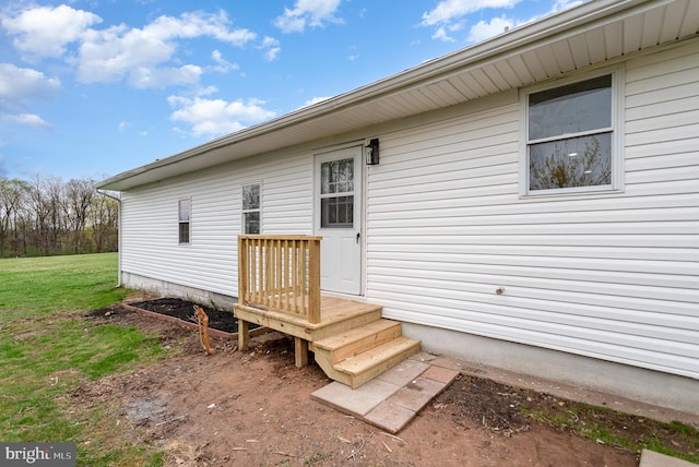 doorway to property featuring a yard