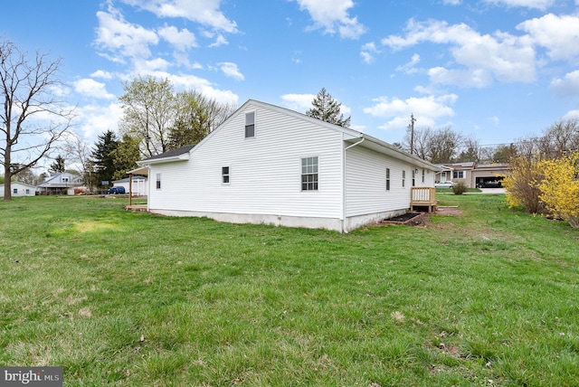 view of home's exterior with a yard