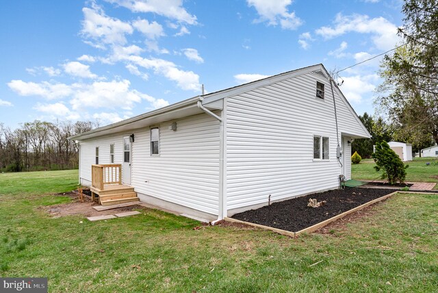 rear view of house with a yard