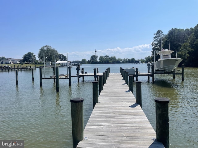 dock area with a water view and boat lift
