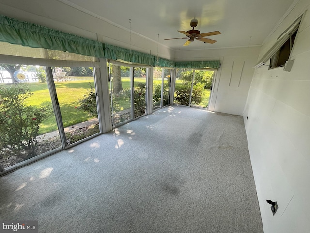 unfurnished sunroom with a ceiling fan