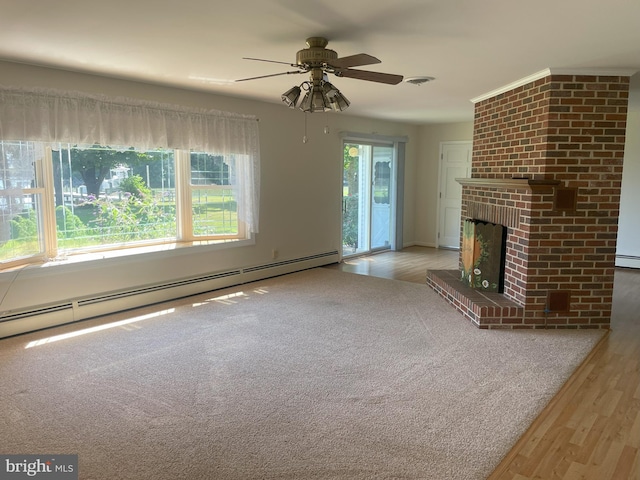 unfurnished living room featuring ceiling fan, a fireplace, wood finished floors, a baseboard heating unit, and a baseboard radiator