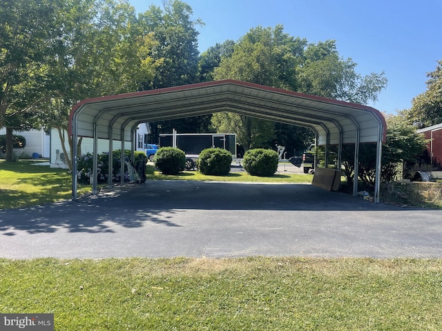 view of car parking with aphalt driveway and a carport