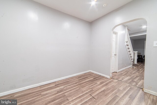 417 E Main St, Millville, NJ 08332 - spare room with arched walkways, baseboards, stairs, and wood finished floors